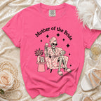 Pink t-shirt with a skeleton graphic reading "Mother of the Bride".