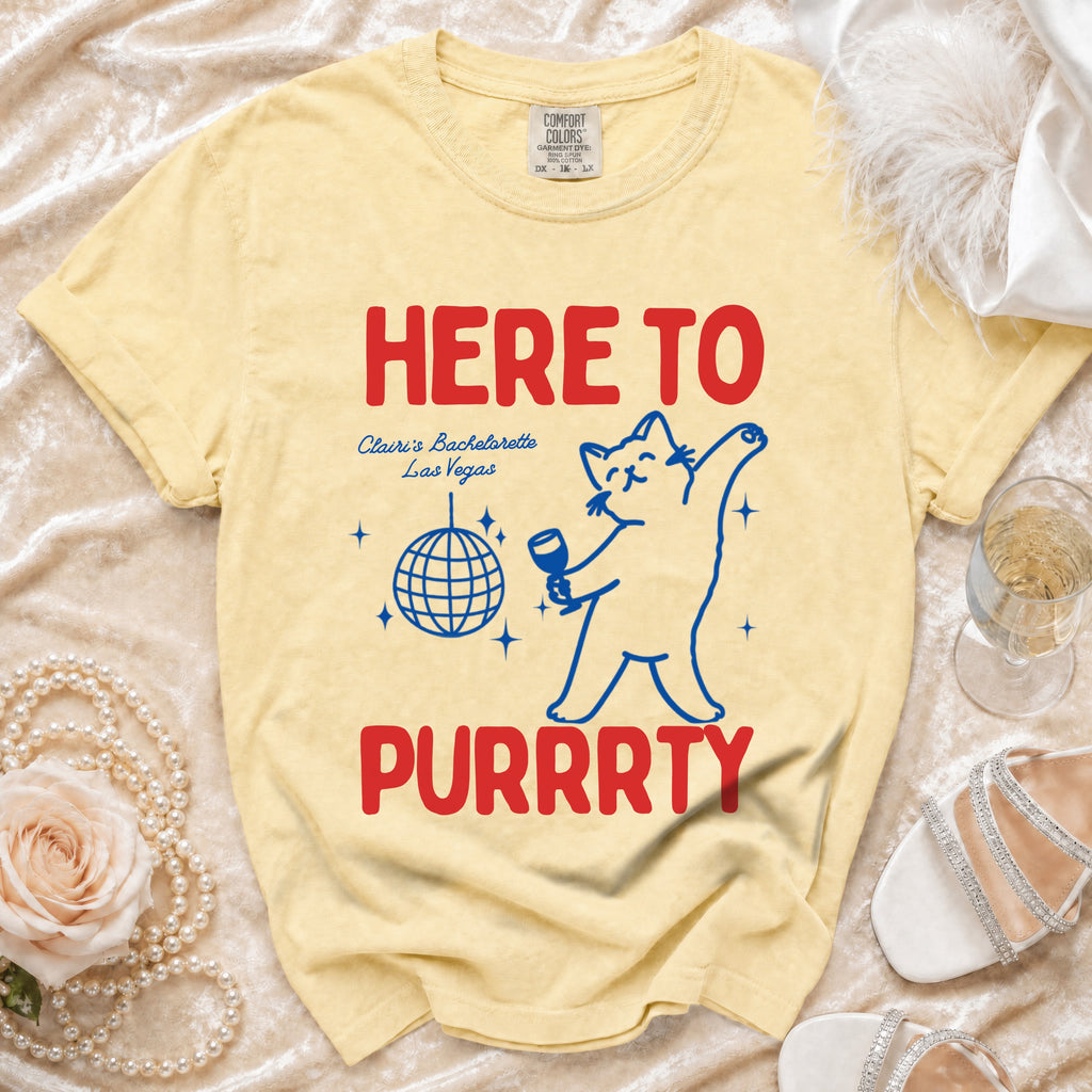 Yellow shirt with cat graphic, reading "HERE TO PURRRTY Clairi's Bachelorette Las Vegas".