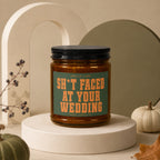 Amber candle with a green label reading "Smells Like Sh*t Faced At Your Wedding."