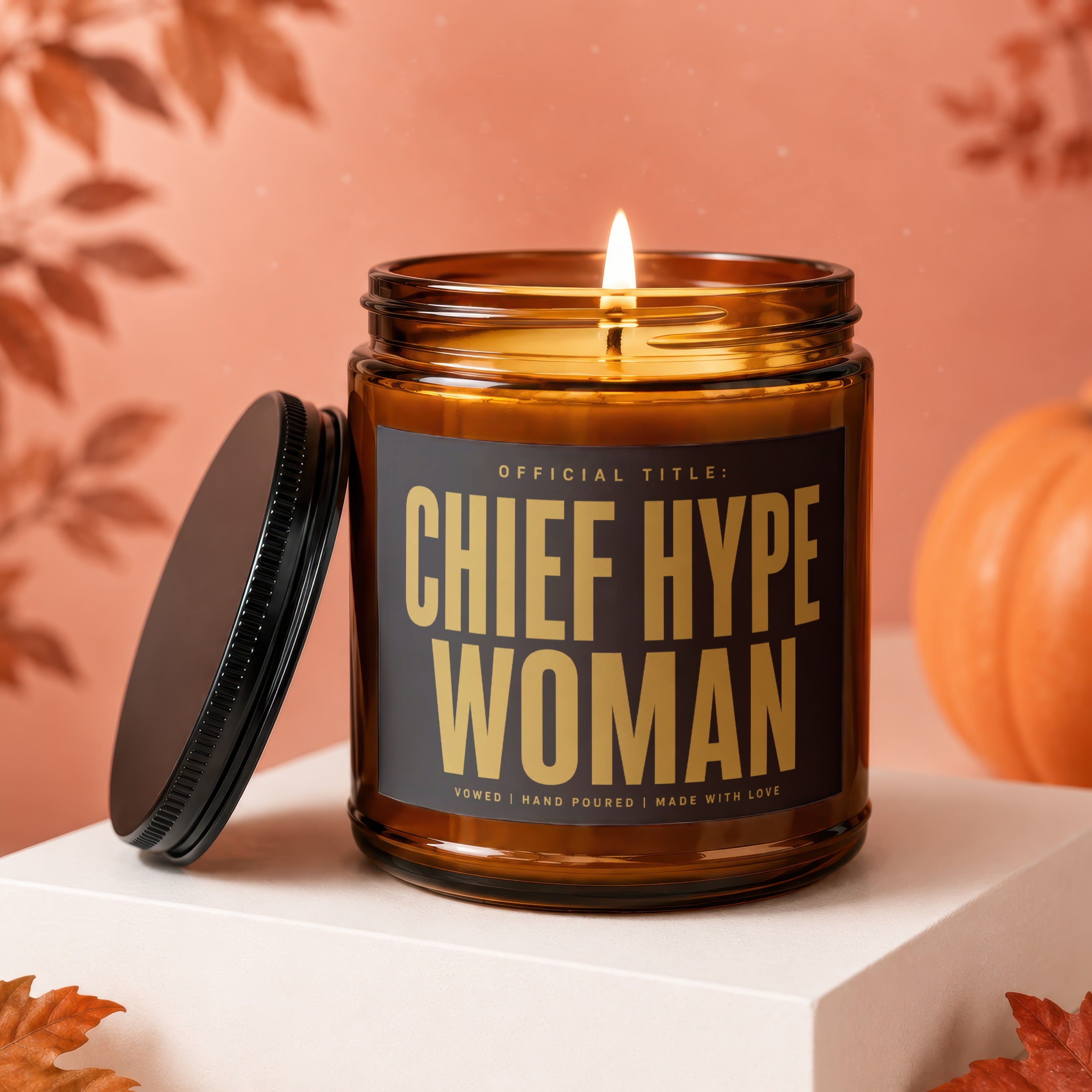 Brown glass candle with lit wick, black lid, and "Chief Hype Woman" label.