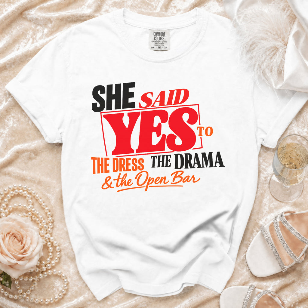 White t-shirt with "She Said Yes to the Dress, The Drama & the Open Bar" graphic.