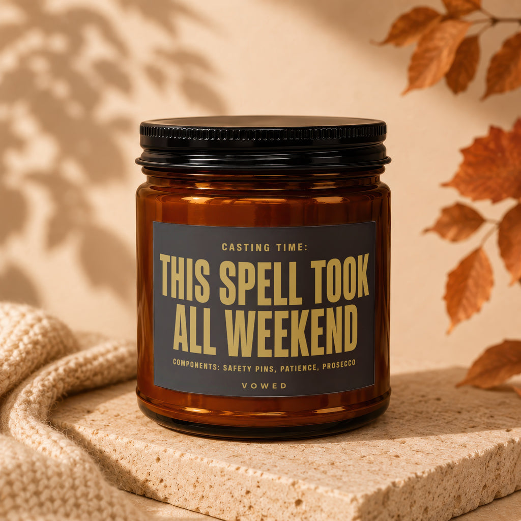 Amber candle with black lid, "This Spell Took All Weekend" text on label.