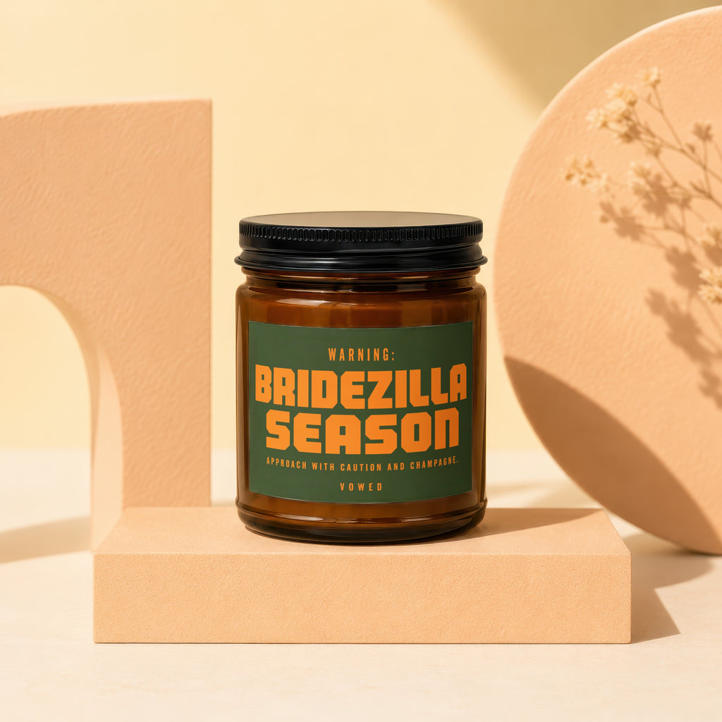 Amber candle with a green label reading "Bridezilla Season" and "Vowed."