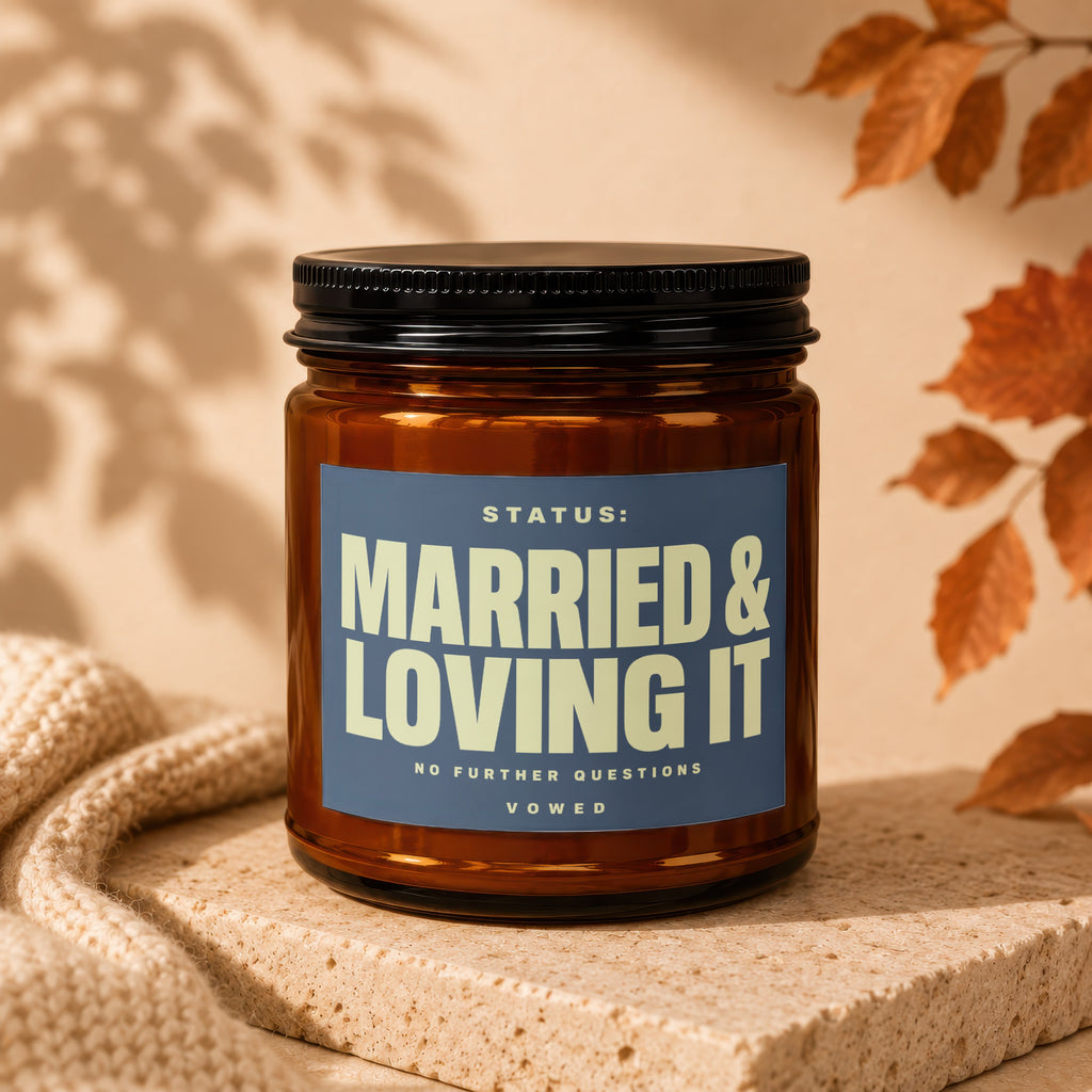 Amber glass candle with "MARRIED & LOVING IT" text on blue label.