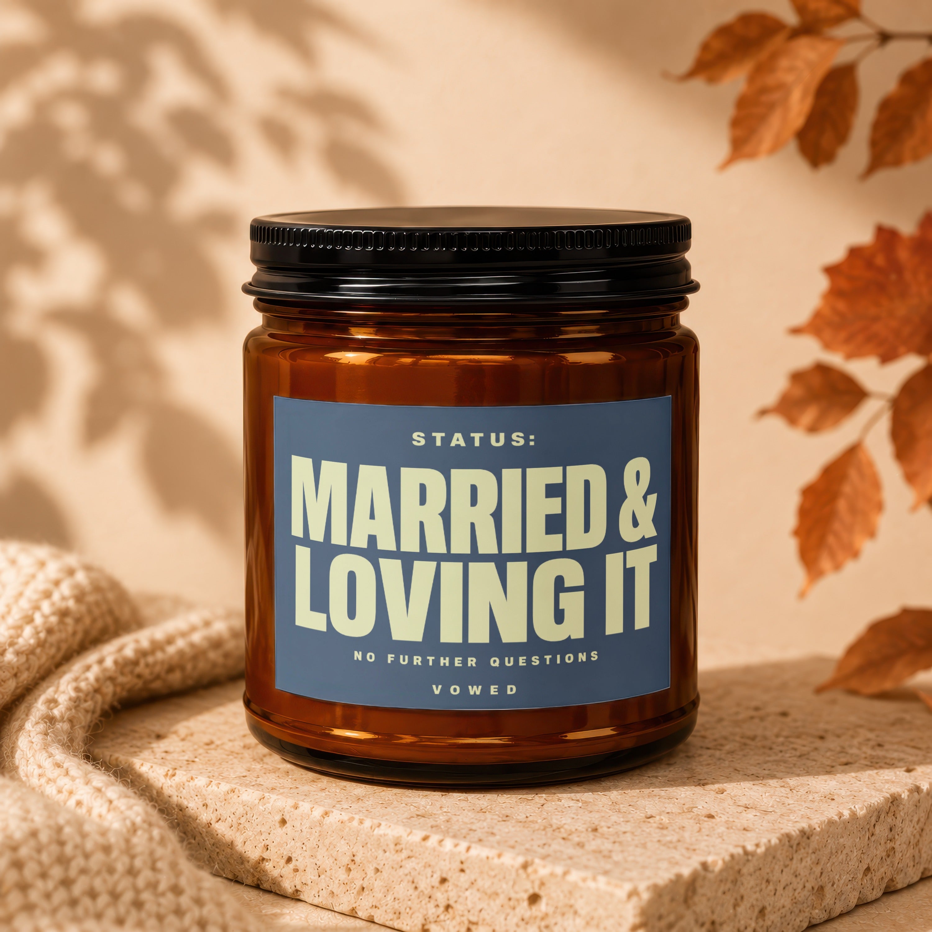 Amber glass candle with "MARRIED & LOVING IT" text on blue label.