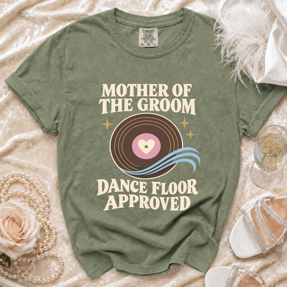 Green t-shirt with "Mother of the Groom Dance Floor Approved" text and vinyl record graphic.