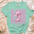 Pink cowboy boots and hat on "Her Last Rodeo" t-shirt with text.