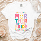 White t-shirt with "Proud Member Mother of the Bride I Gave Her Away. You're Welcome." text.