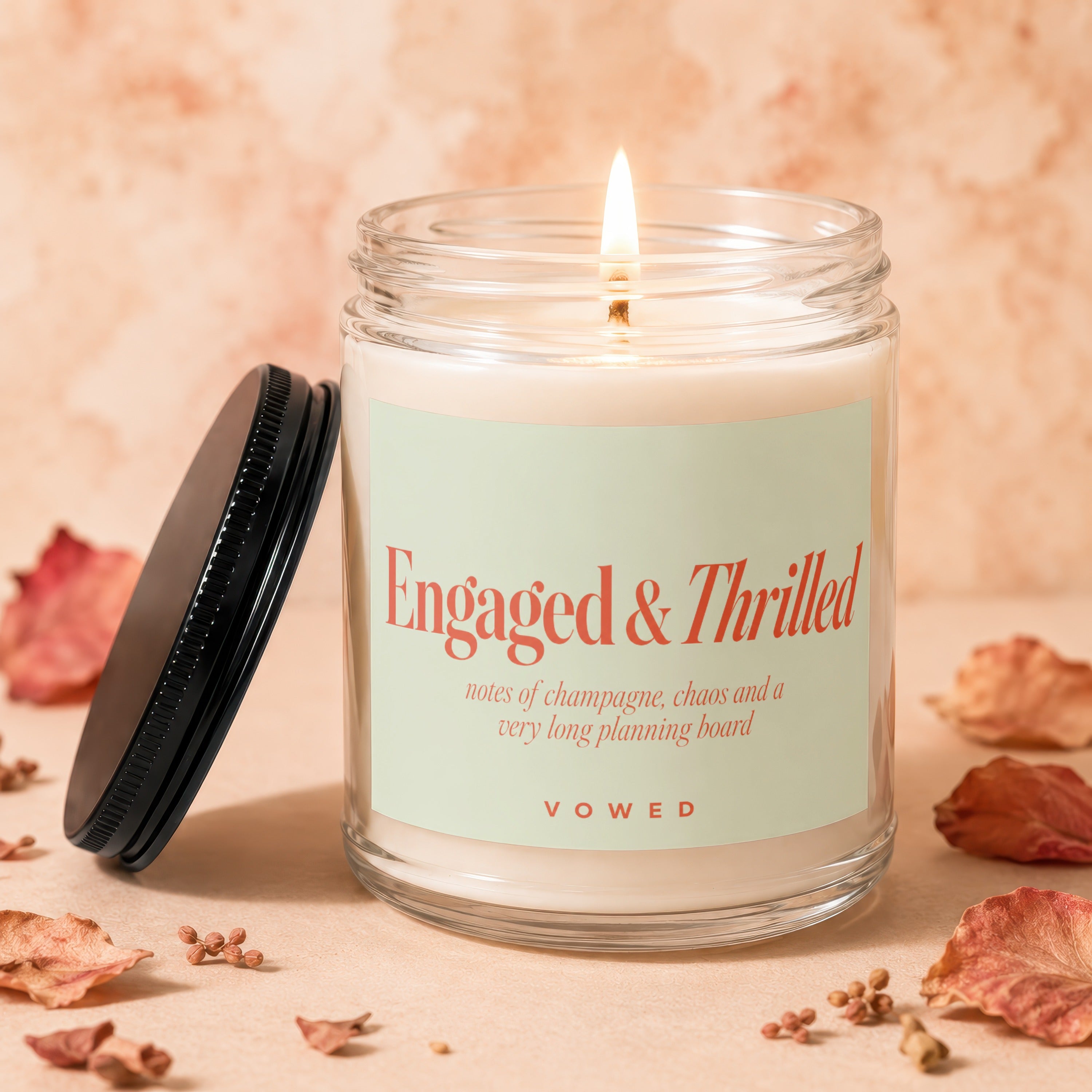 Engaged & Thrilled candle with text notes of champagne, chaos and a very long planning board.