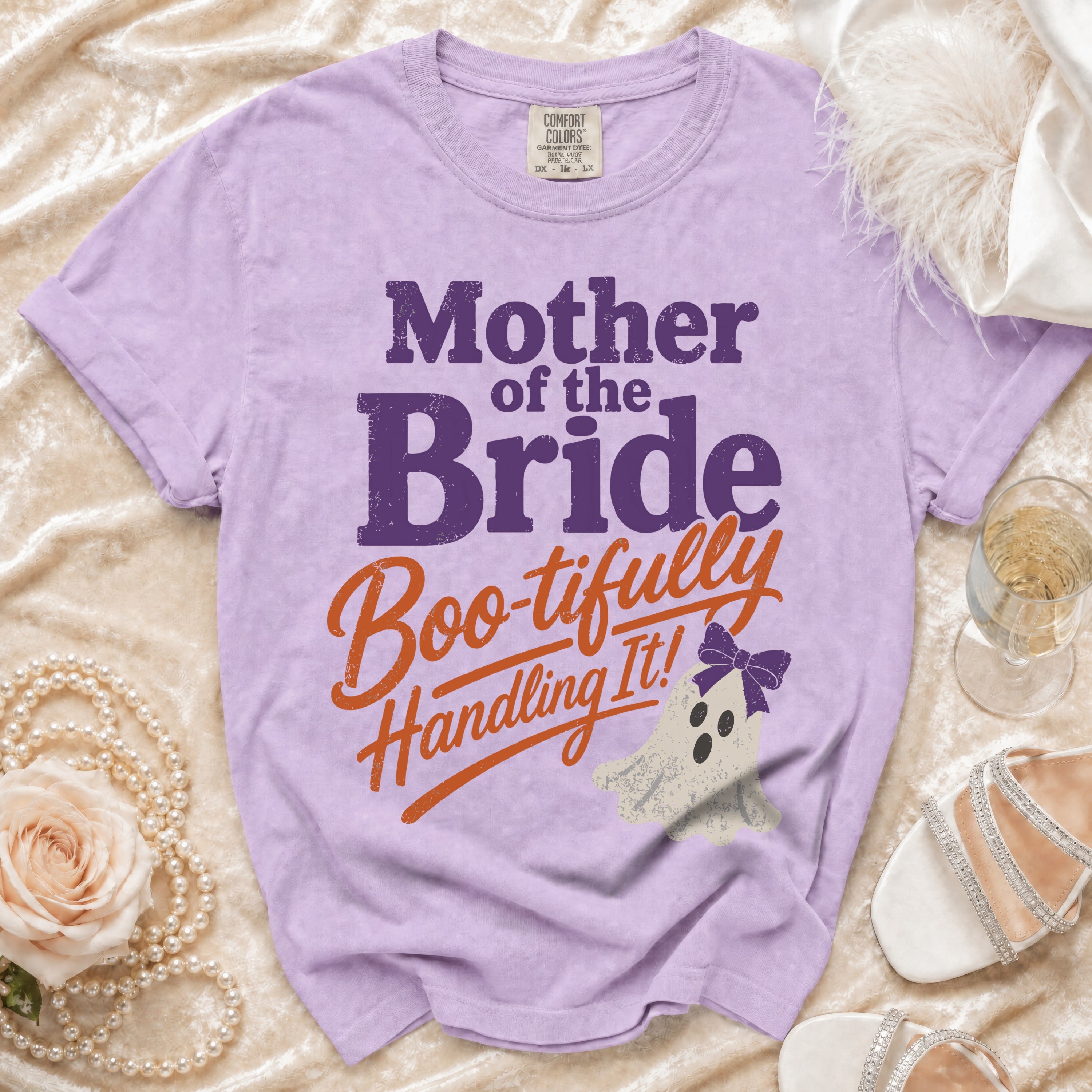 Purple Comfort Colors t-shirt with "Mother of the Bride Boo-tifully Handling It!" text and ghost graphic.