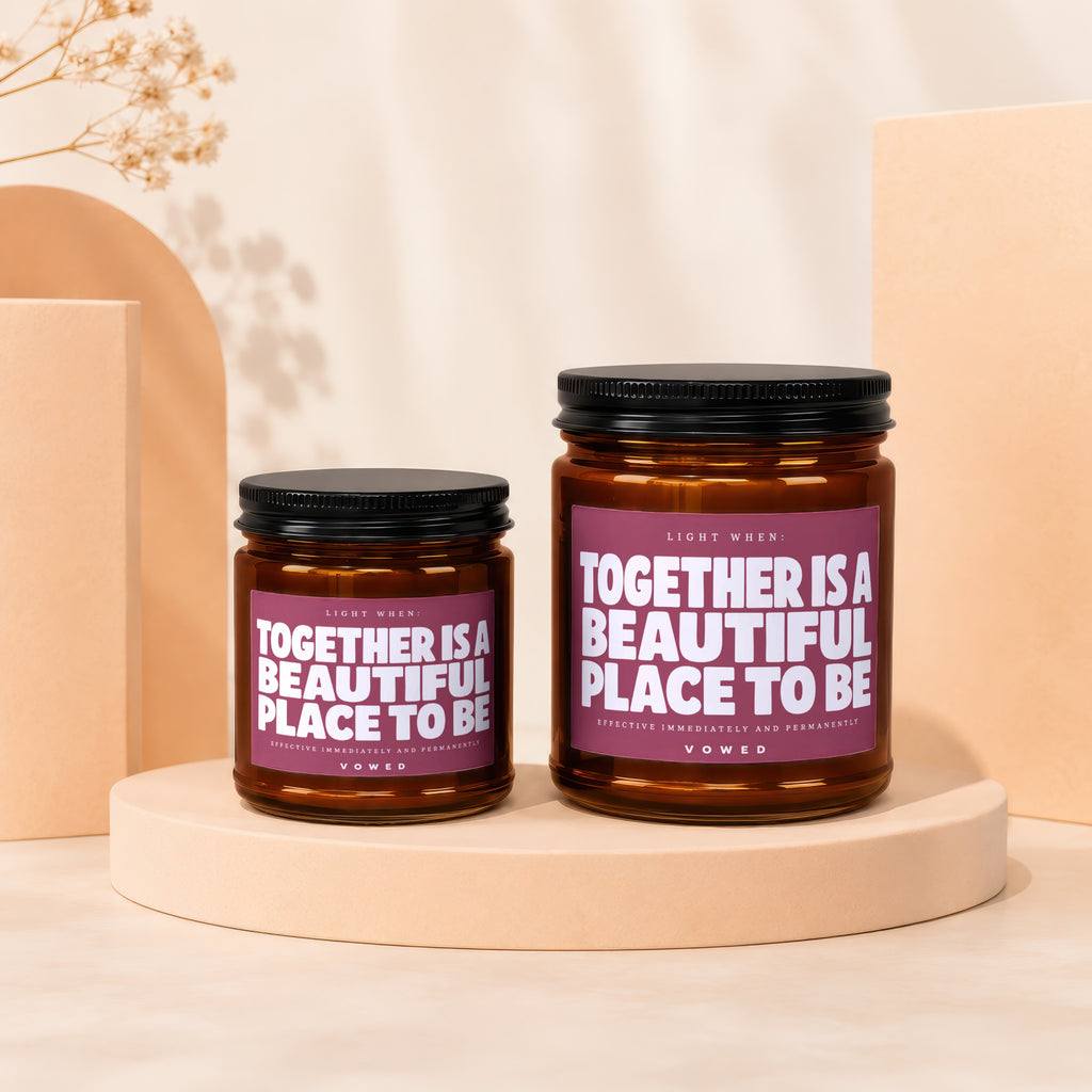 Two brown glass candles with labels stating "Together is a beautiful place to be."