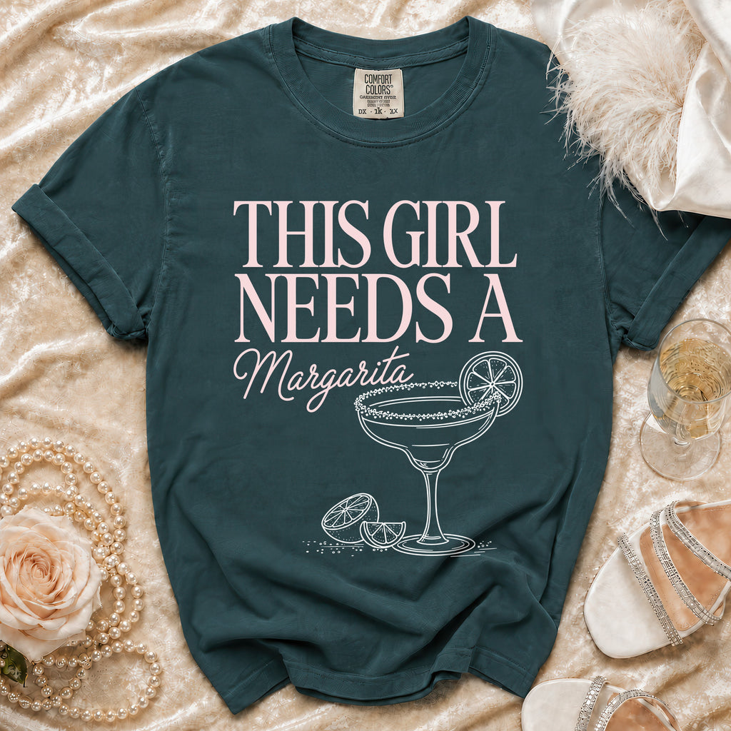 Teal t-shirt with pink text "THIS GIRL NEEDS A Margarita" and margarita graphic.
