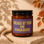 Brown glass candle with purple label reading "Smells Like Head B\*tch In Charge".