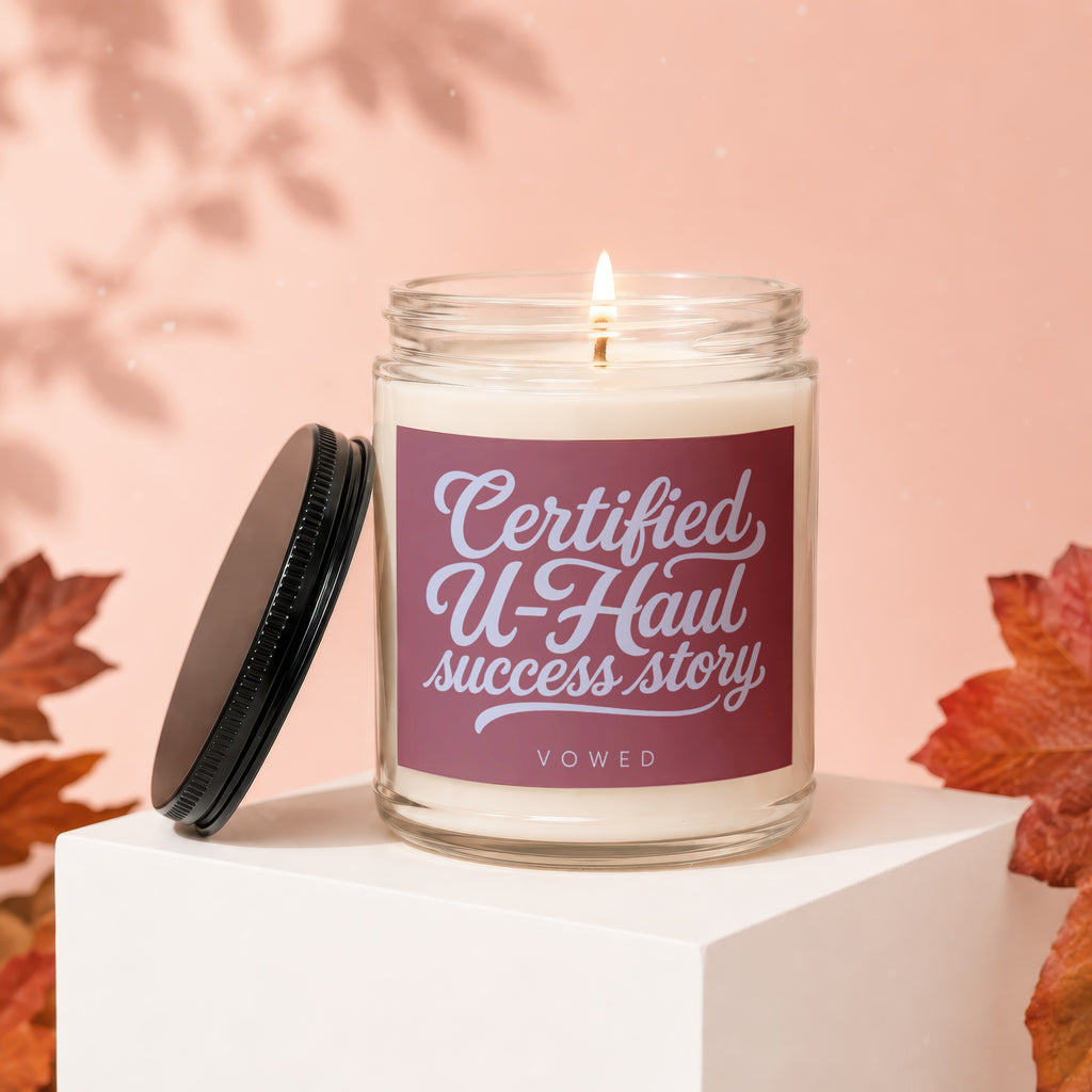 Glass candle with "Certified U-Haul success story" text on label.