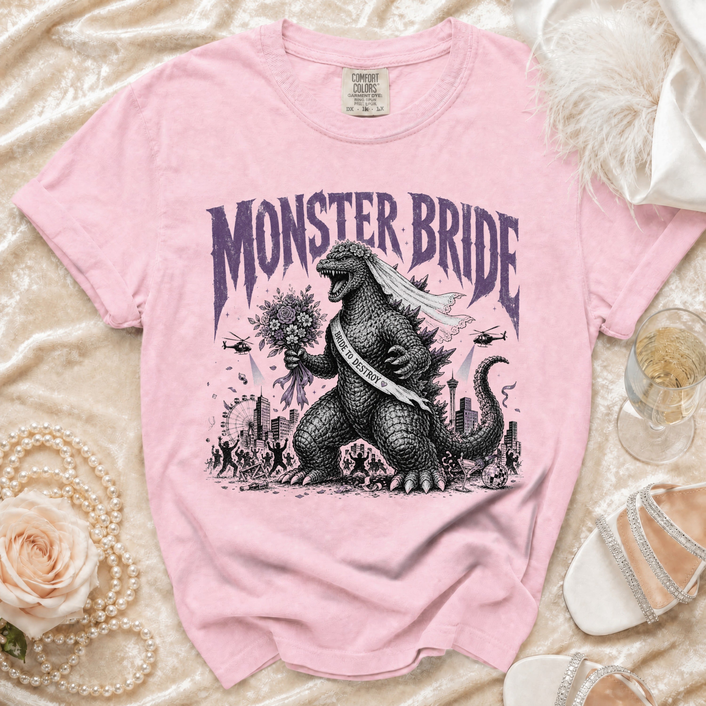 Pink t-shirt with "Monster Bride" print featuring Godzilla and city scape.