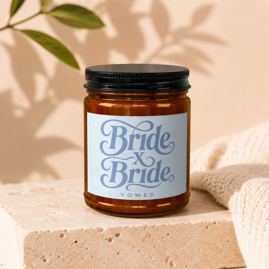 Amber jar candle with a light blue label that reads "Bride x Bride VOWED".