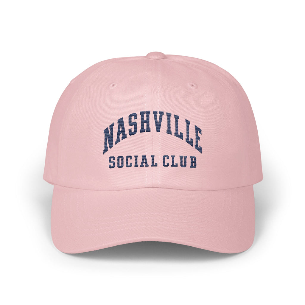 Light pink baseball cap embroidered with dark blue text reading Nashville Social Club on the front.