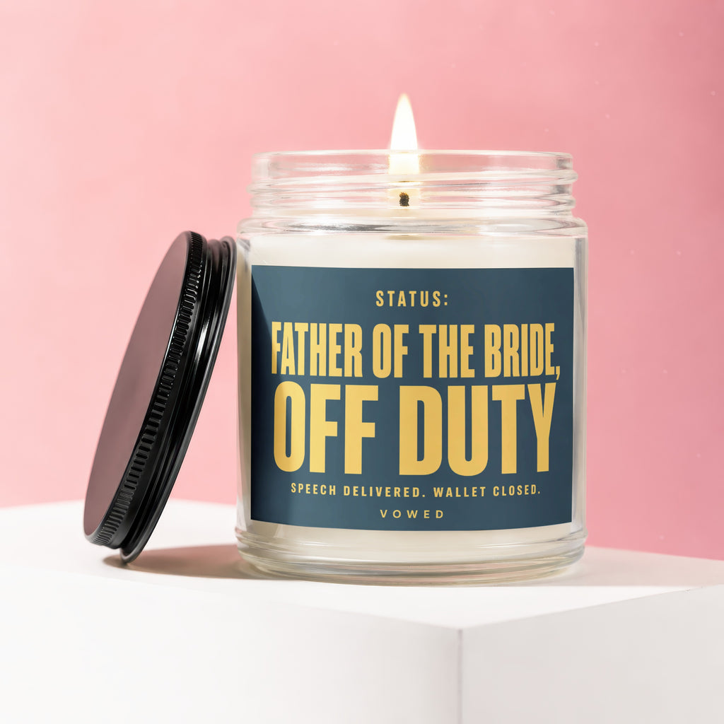 Glass candle with dark blue label stating "Father of the Bride, Off Duty".