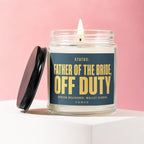 Glass candle with dark blue label stating "Father of the Bride, Off Duty".