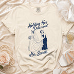 Cream t-shirt with "Holding Her Dress and Her Secrets" graphic of two women.