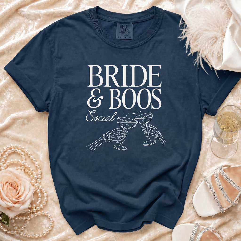 Navy blue t-shirt with "BRIDE & BOOS Social" and skeleton hands toasting champagne glasses.