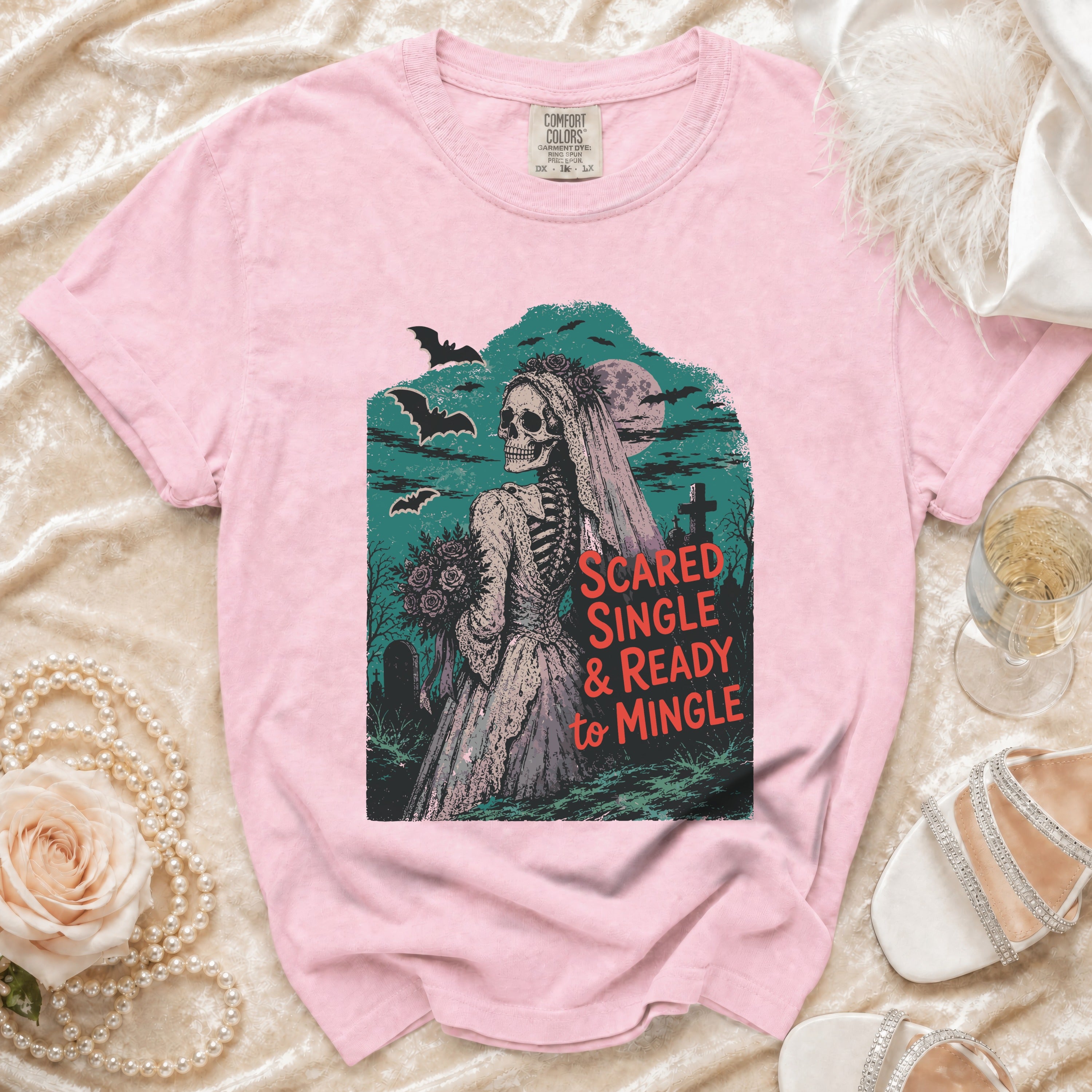 Pink t-shirt with skeleton bride graphic and text "Scared Single & Ready to Mingle".