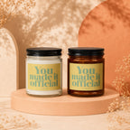 Two candles on a pedestal, each with a "You made it official" label.
