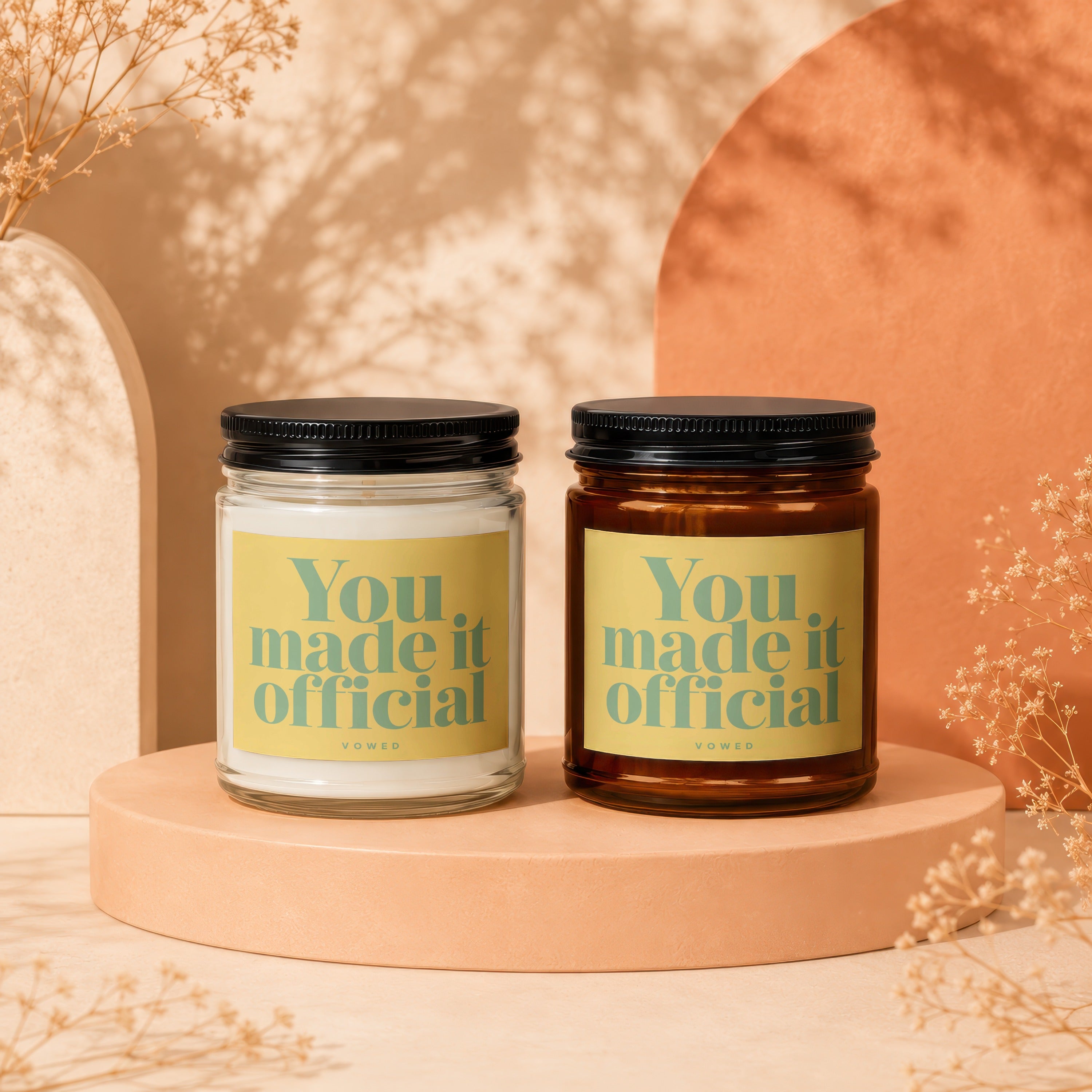 Two candles on a pedestal, each with a "You made it official" label.