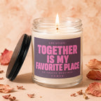 Glass jar candle with lit wick and label reading "Together is My Favorite Place".