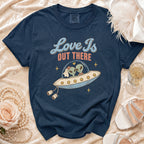 Navy t-shirt with "Love Is Out There" graphic of aliens in a UFO.