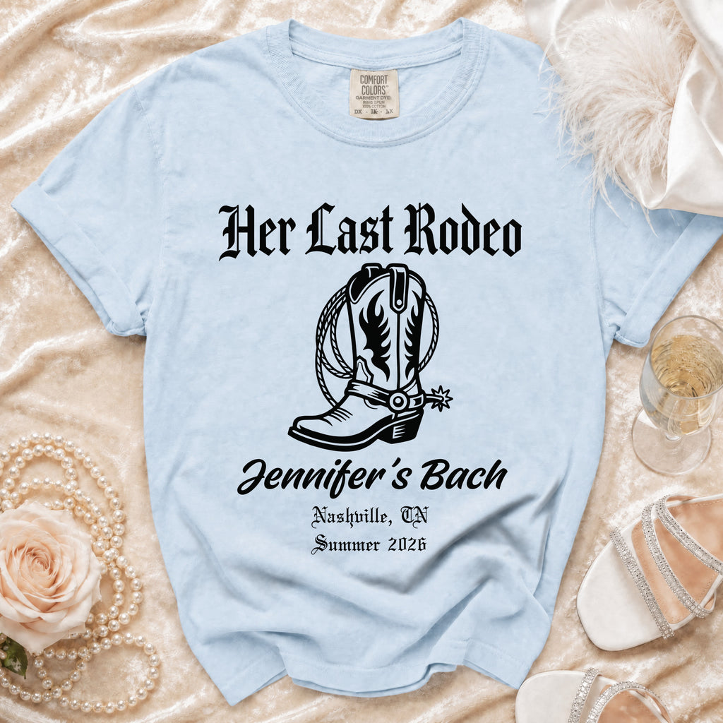 Light blue t-shirt with "Her Last Rodeo" and cowboy boot design.