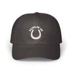 Dark gray baseball cap with an embroidered white horseshoe design and the text SADDLIN UP.