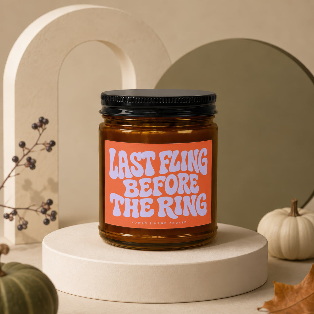 Amber jar candle with orange label reading "Last Fling Before The Ring".