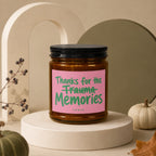 Amber jar candle with pink label reading "Thanks for the Trauma Memories"