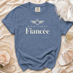 Blue t-shirt with "First Class Fiancée" text and diamond ring graphic.
