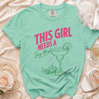 Mint green t-shirt with "THIS GIRL NEEDS A Spicy Marg" text and margarita graphic.