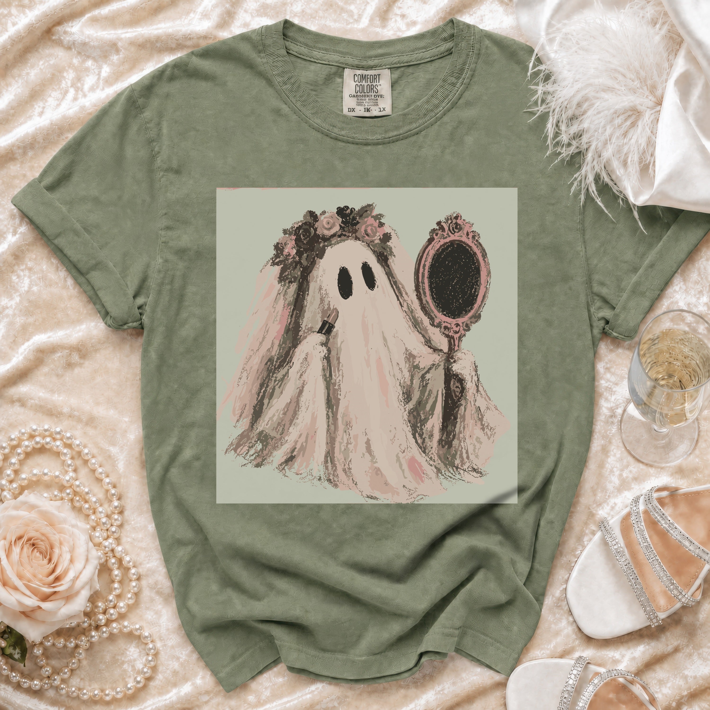 T-shirt with graphic of a ghost holding lipstick and a mirror.