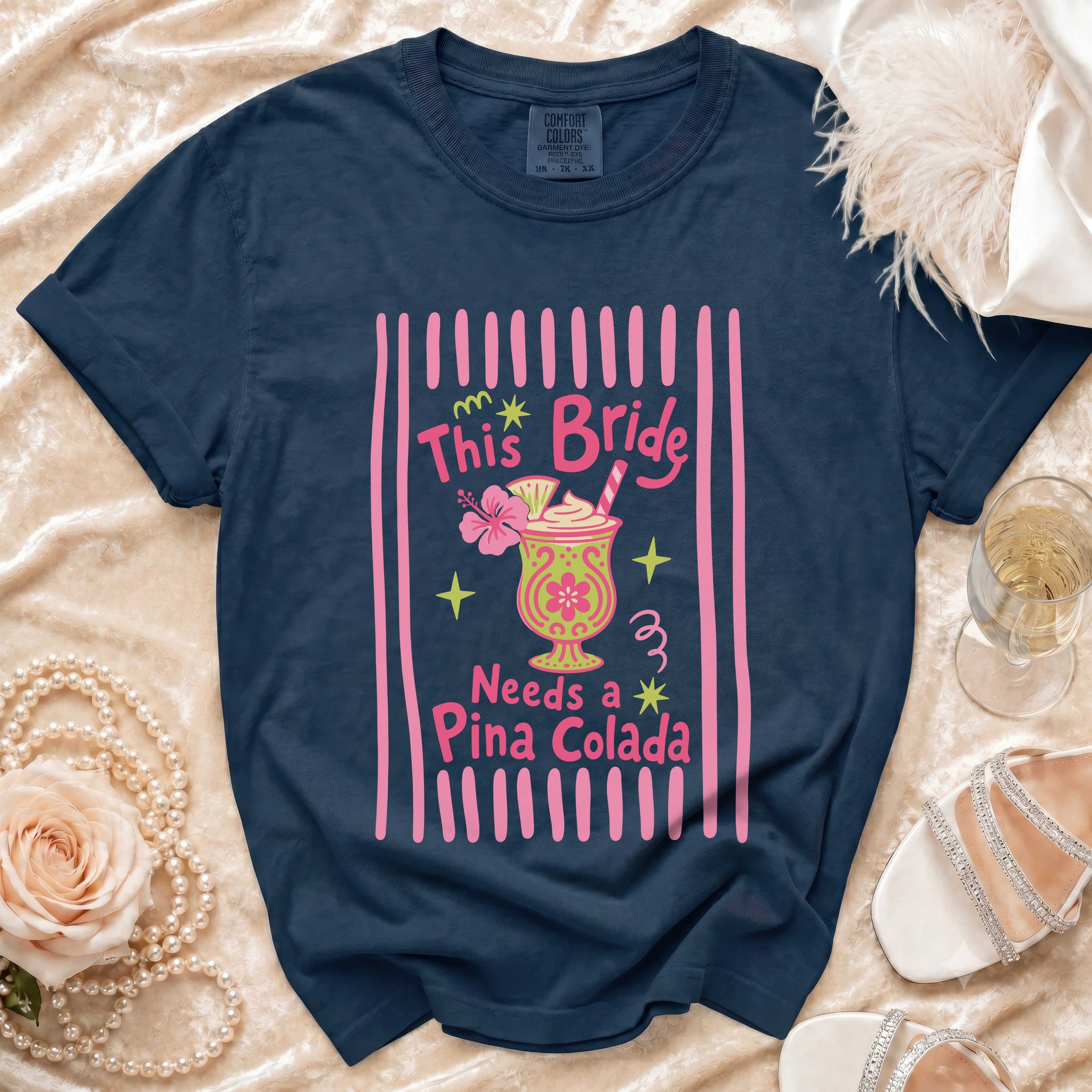 Navy t-shirt with "This Bride Needs a Pina Colada" text and graphic.
