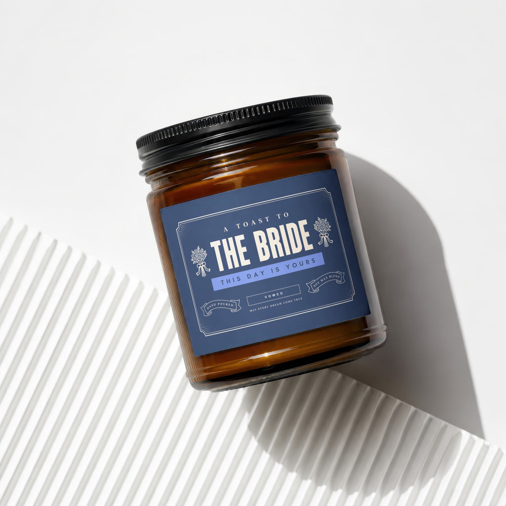 Amber jar candle with blue label reading "A Toast to the Bride This Day is Yours".