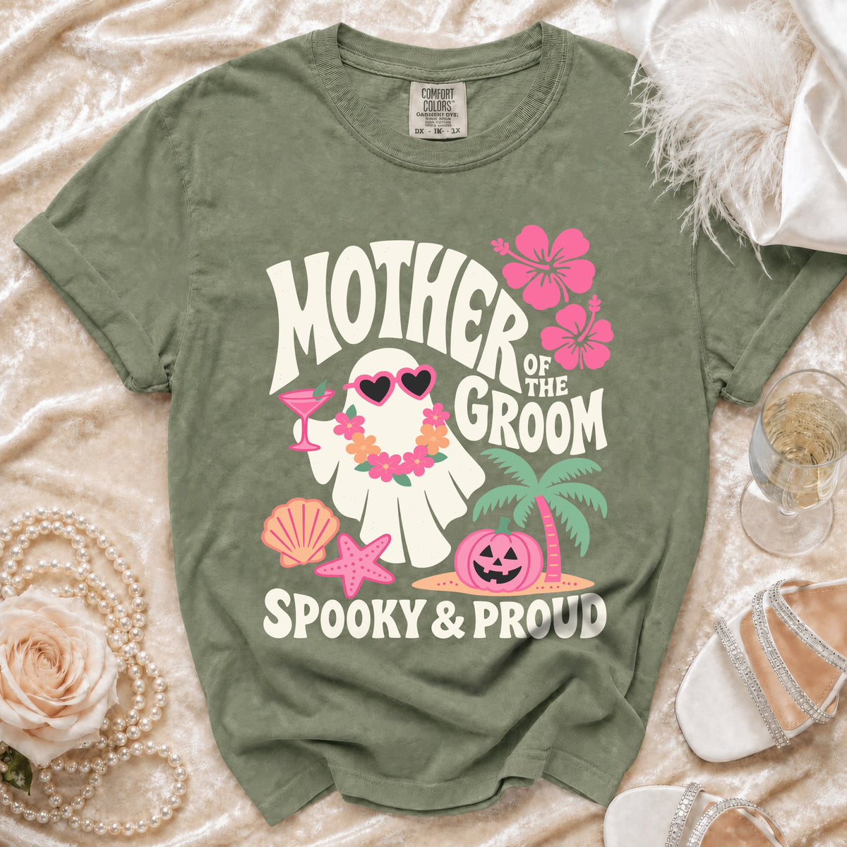 Green t-shirt with ghost, hibiscus, pumpkin, and text "Mother of the Groom Spooky & Proud".