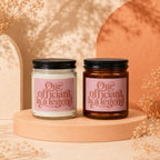 Two candles, each reading "Our officiant is a legend" in pink lettering.