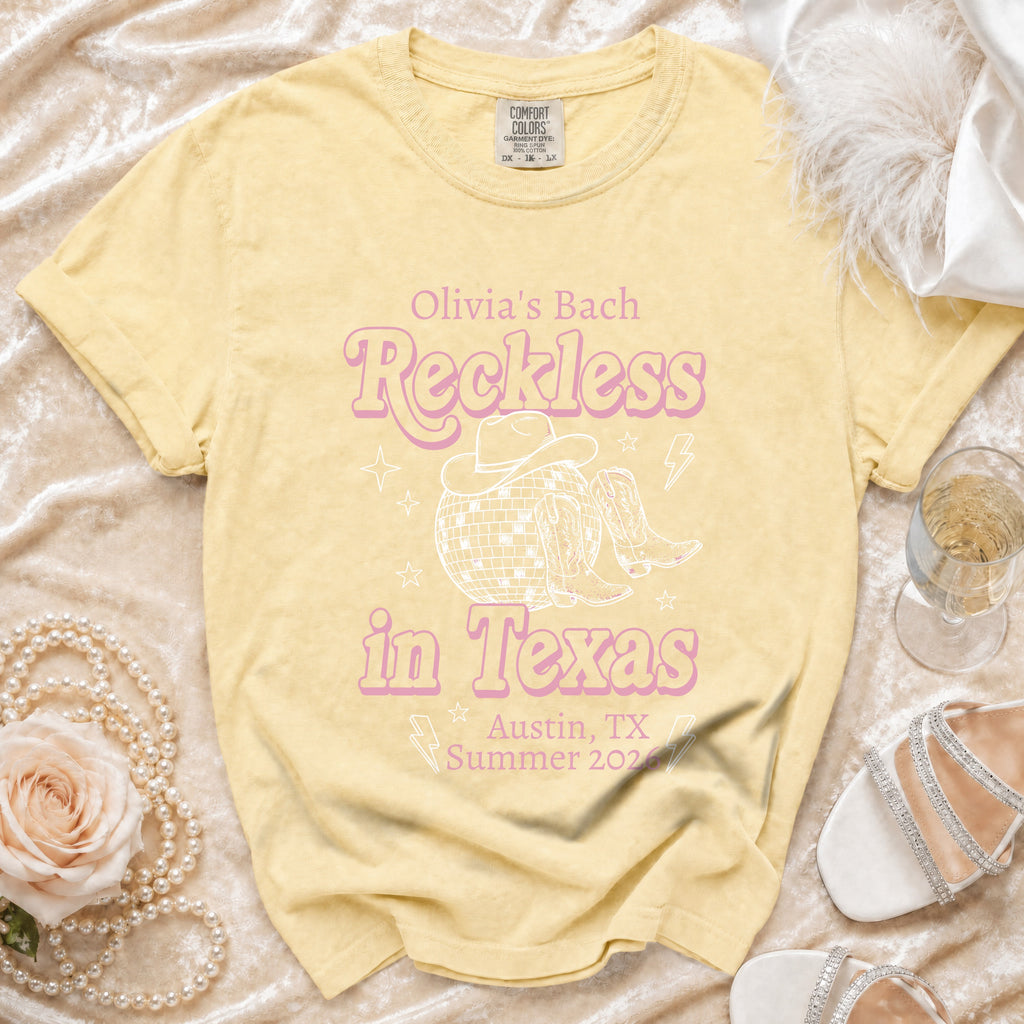 Light yellow t-shirt with "Olivia's Bach Reckless in Texas Austin, TX Summer 2026" text.