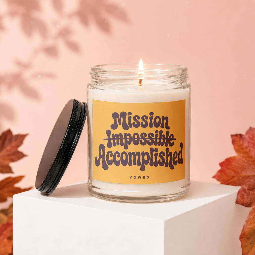 Candle with "Mission Impossible Accomplished" text on a yellow label.