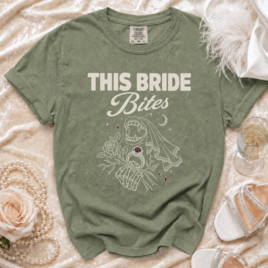Olive green t-shirt with "THIS BRIDE Bites" text and vampire graphic.