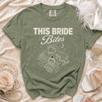 Olive green t-shirt with "THIS BRIDE Bites" text and vampire graphic.