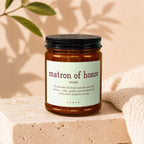 "Matron of Honor" noun definition candle in amber glass jar.
