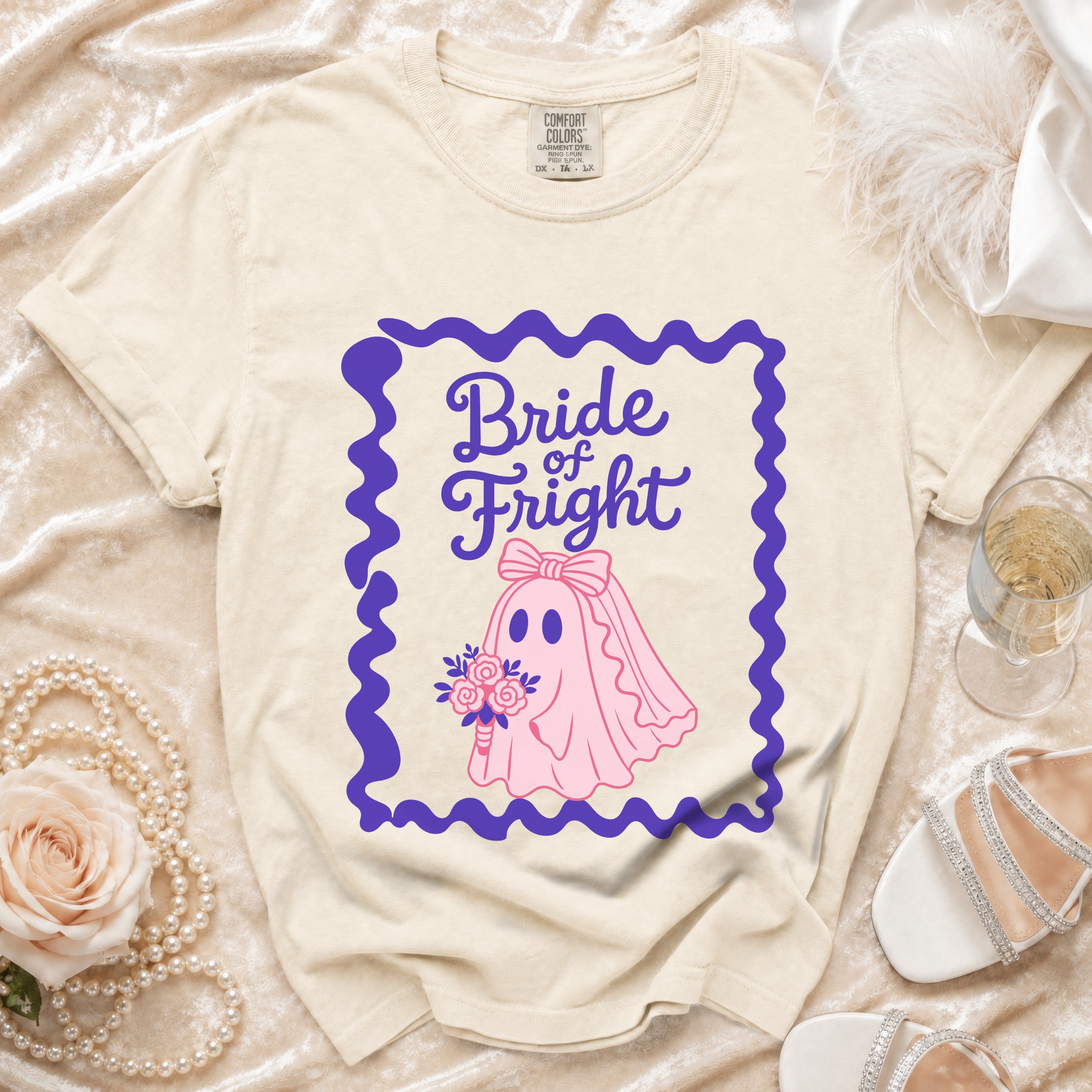 Light-colored t-shirt with a pink ghost bride graphic reading "Bride of Fright."