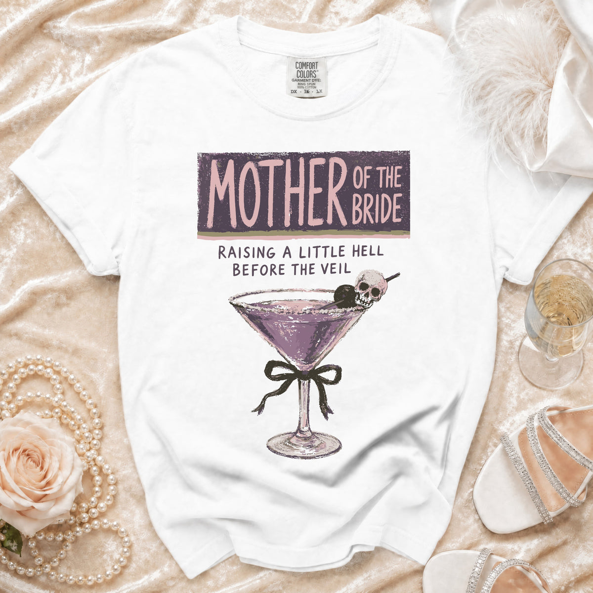 White t-shirt with "Mother of the Bride Raising a Little Hell Before the Veil" text.