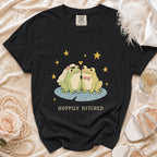 Black t-shirt with bride and groom frogs and "Hoppily Hitched" text.