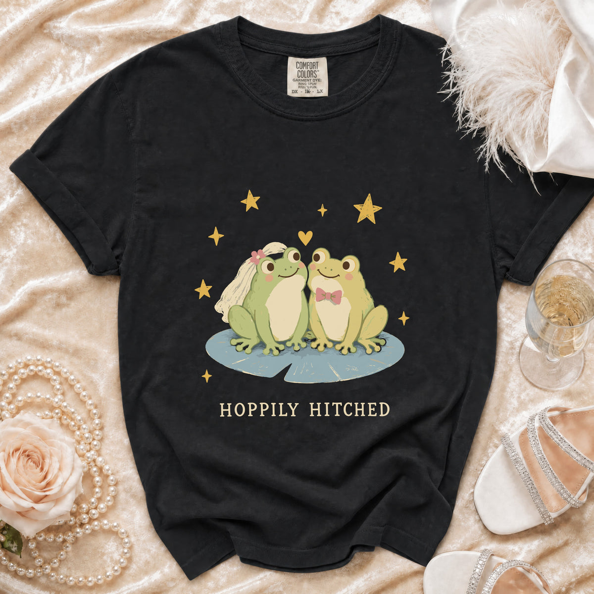 Black t-shirt with bride and groom frogs and "Hoppily Hitched" text.